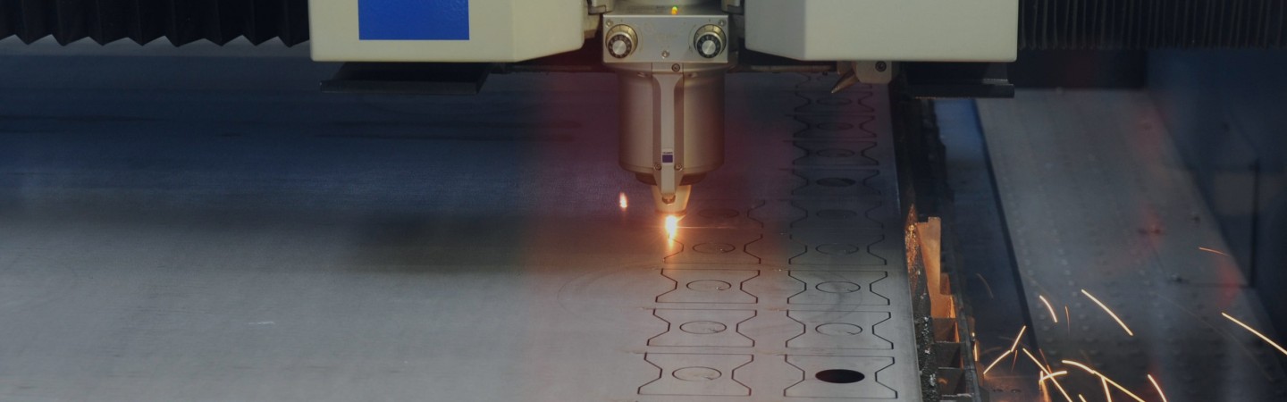 Machine laser cutting shapes out of metal
